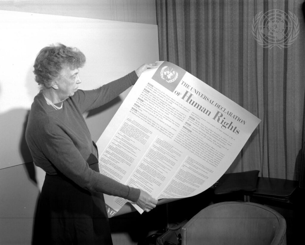 Mrs. Eleanor Roosevelt of the United States holding a Declaration of Human Rights poster in English. 